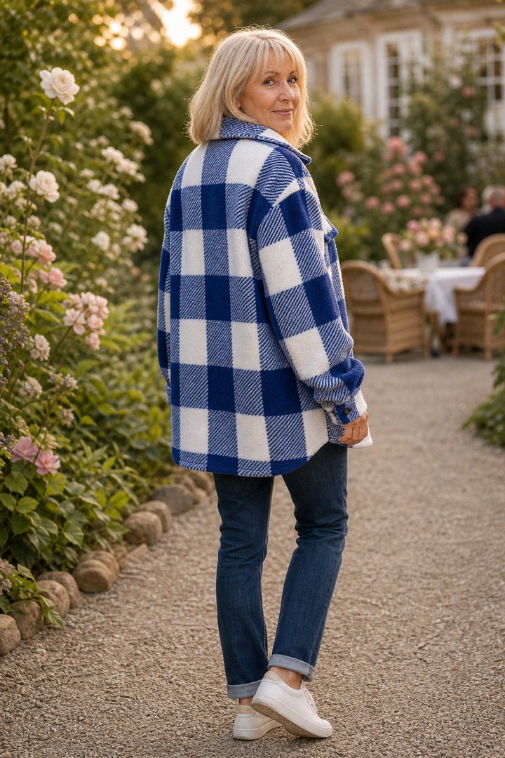 Back view of a blue buffalo check sherpa overshirt on a path