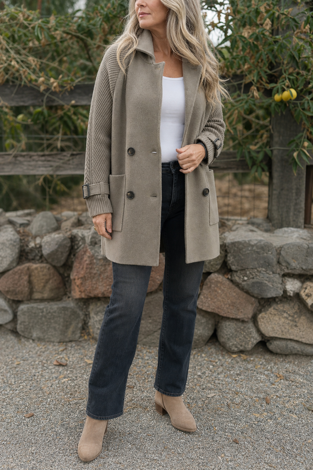 Taupe longline coat with a stand collar worn with dark jeans