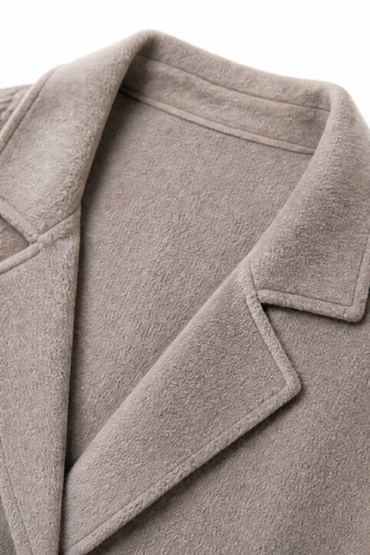 Close up of the notch lapel on a taupe wool blend coat