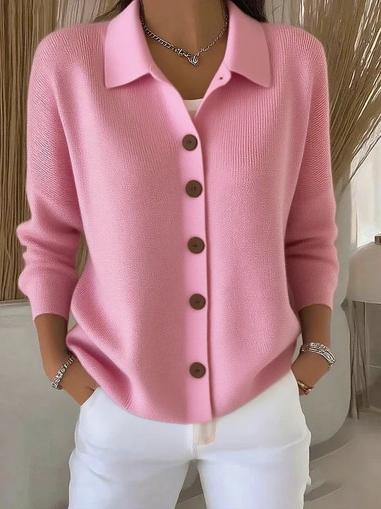 Pink collared button-up knit cardigan worn with white trousers