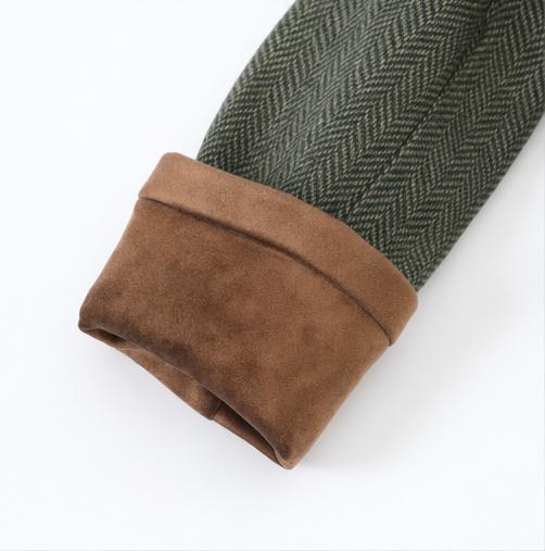 Brown suede contrast cuff on a green herringbone jacket sleeve
