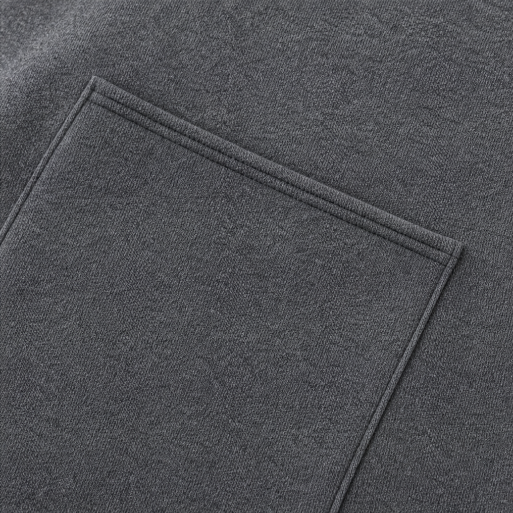 Topstitched pocket outline on a charcoal packable travel jacket