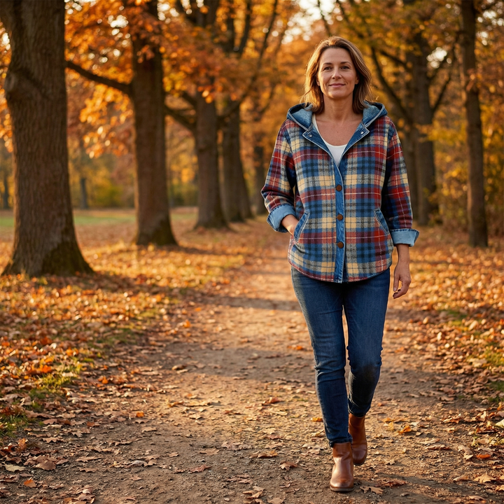 Woman on an autumn path in a plaid denim trim hooded jacket
