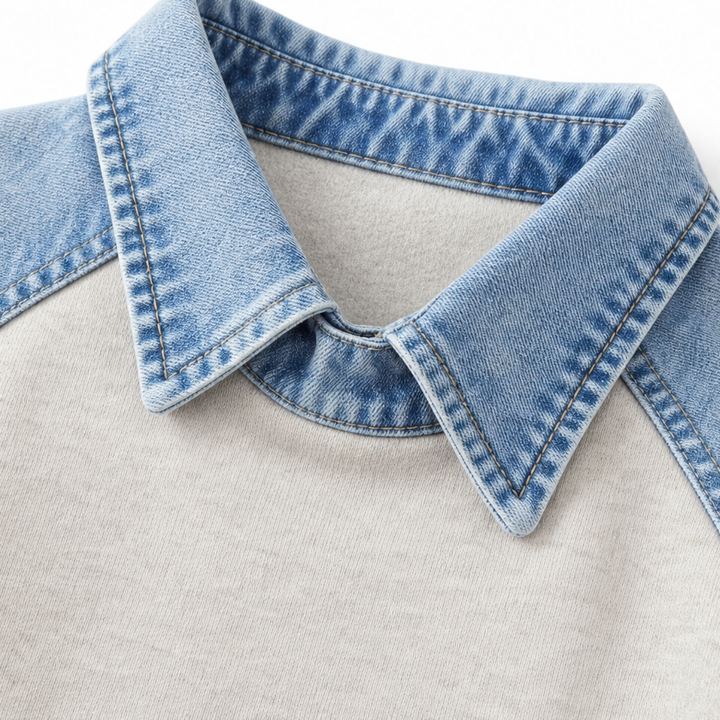 Close up of the light denim collar on a cream sweatshirt