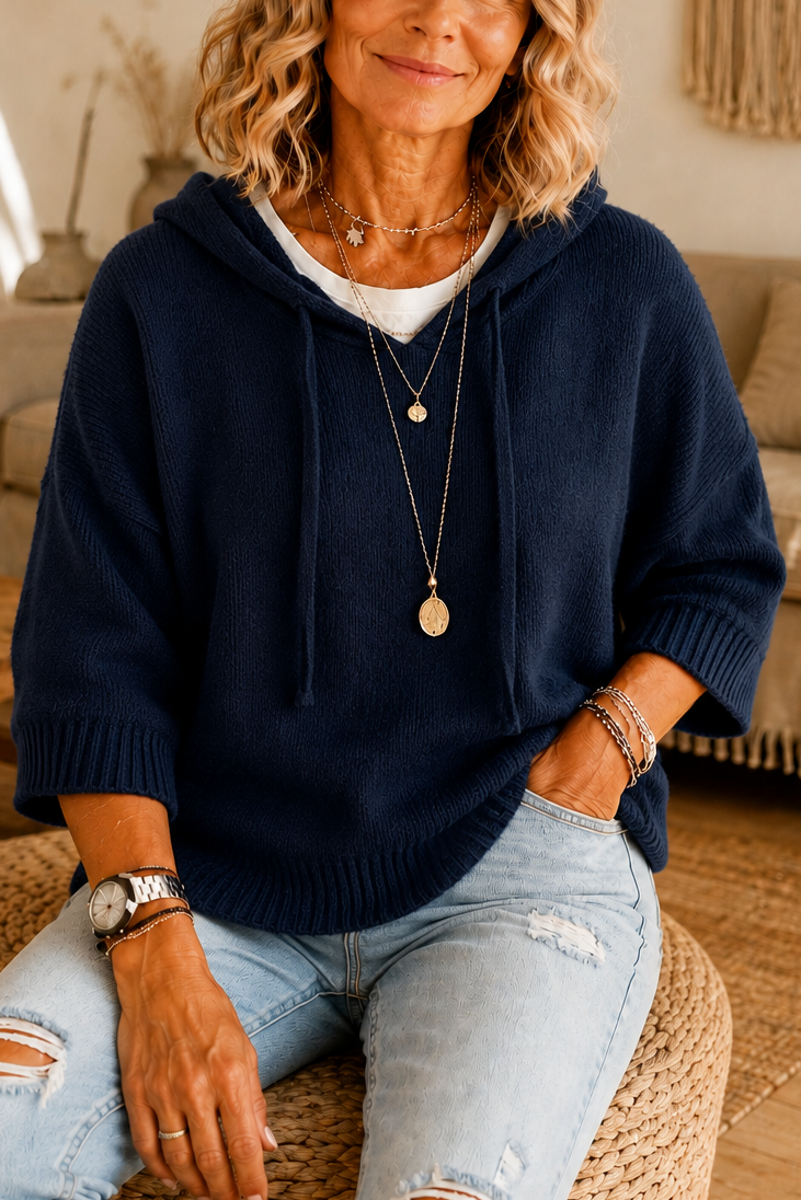 Navy knit hoodie with elbow sleeves and a drawstring hood