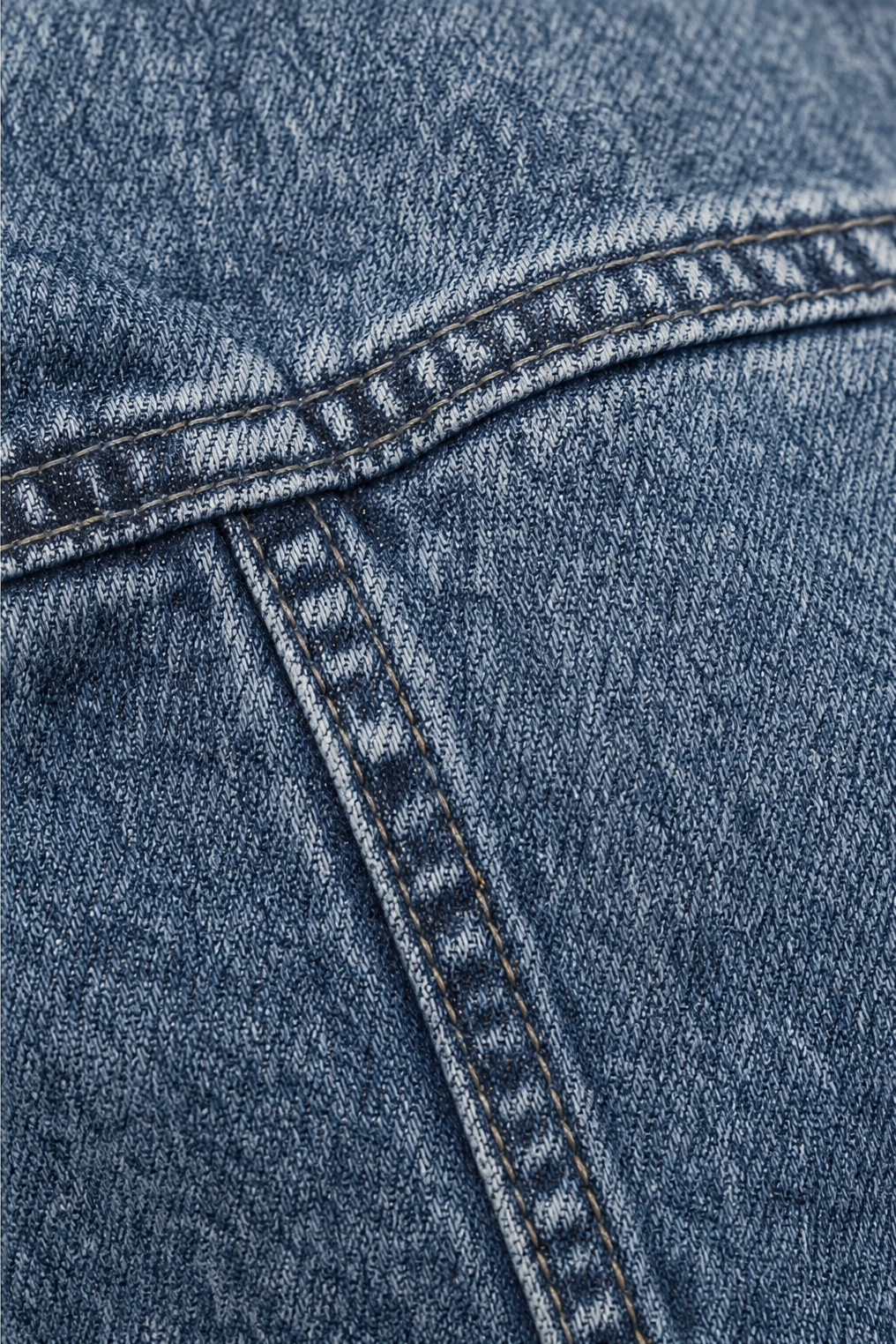 Close up of the ruffled seam trim on a denim jacket