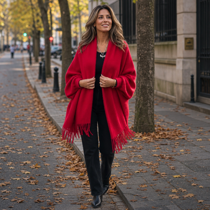 Woman on an autumn avenue in a red fringed shawl wrap