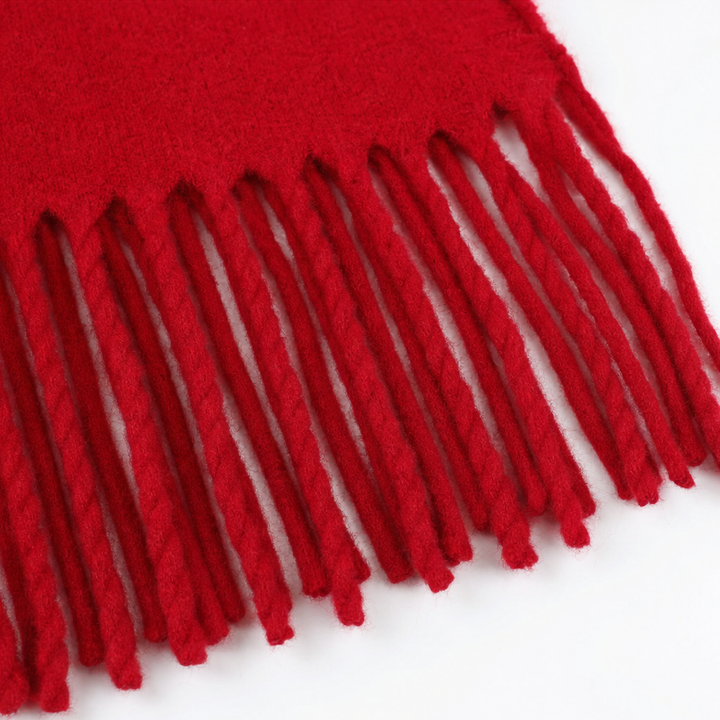 Knotted fringe edge on a red wool wrap