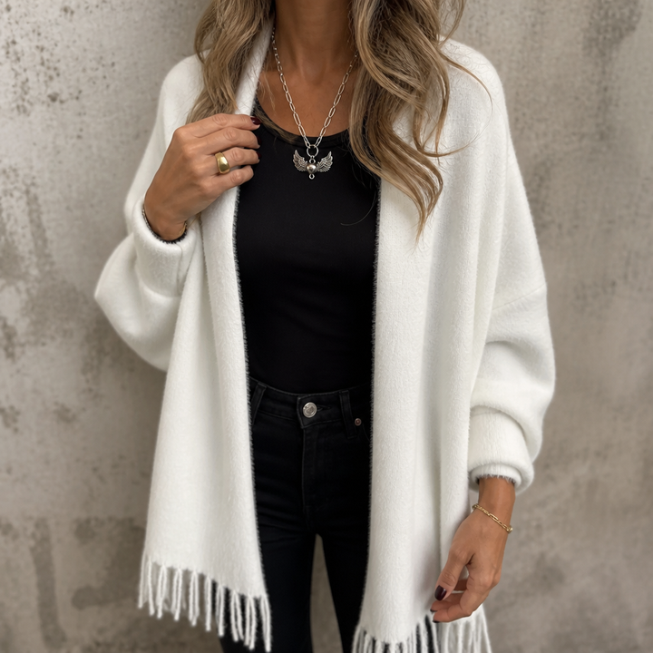 Ivory draped shawl collar wrap with a fringed hem