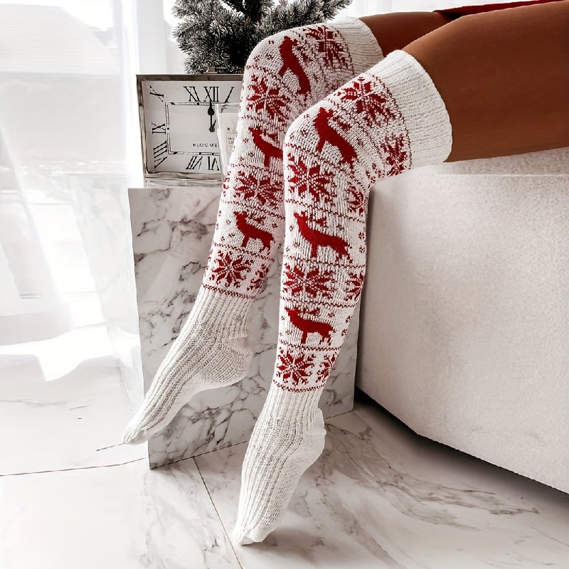 White knit knee high socks with a red reindeer and snowflake pattern, worn