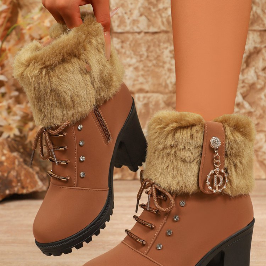 Tan faux fur cuff boots with a crystal charm, worn indoors