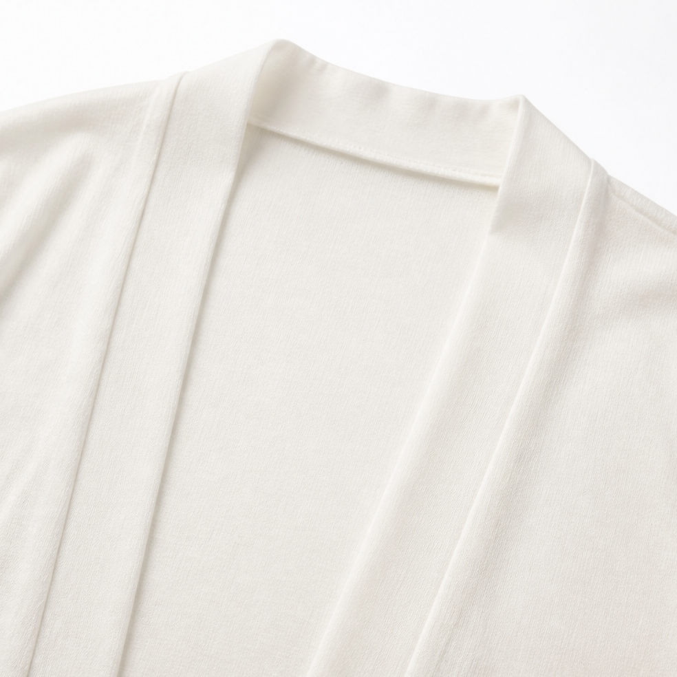 Close up of the shawl collar on an ivory fine knit cardigan