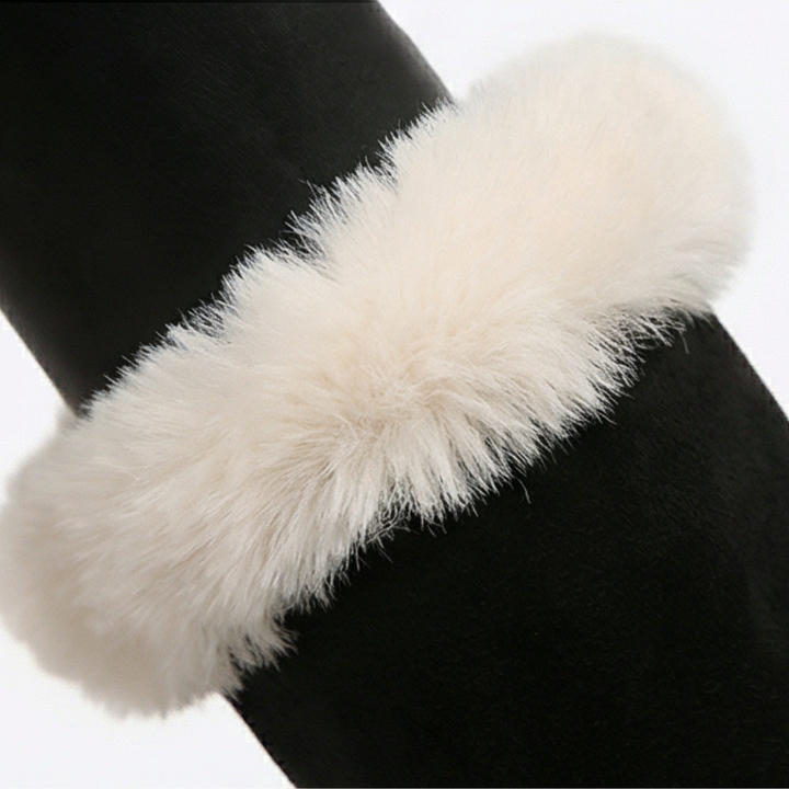 Close up of the cream faux fur cuff on a black suede boot