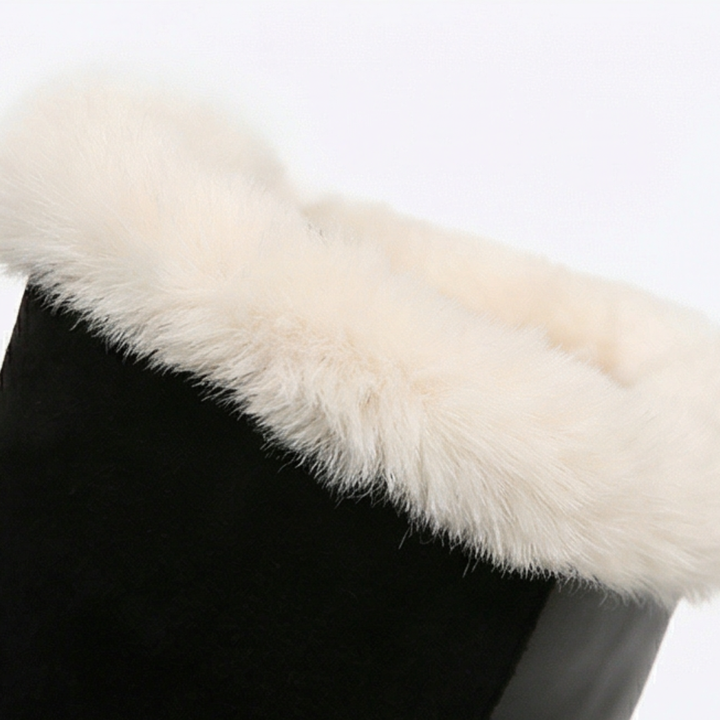 Cream faux fur trim folded over the shaft of a black boot