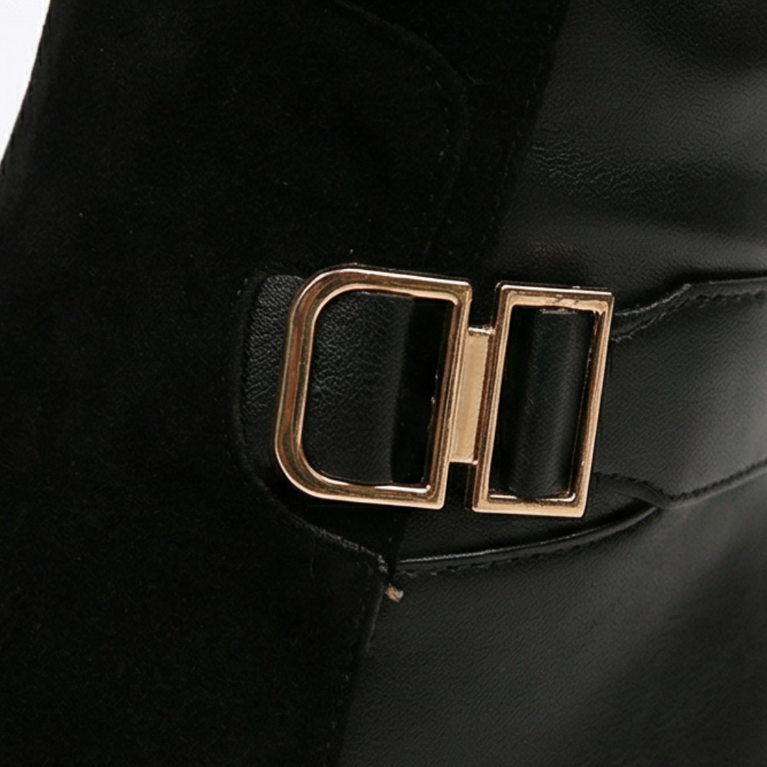 Gold double buckle detail on a black knee high boot