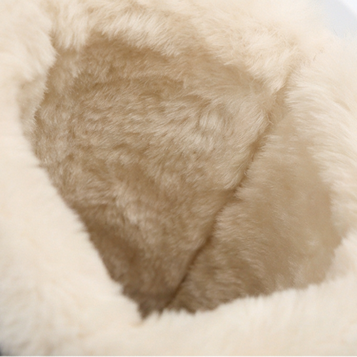 Cream plush fleece lining inside a black knee high boot