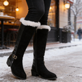 Black knee high boots with cream faux fur cuffs worn in snow