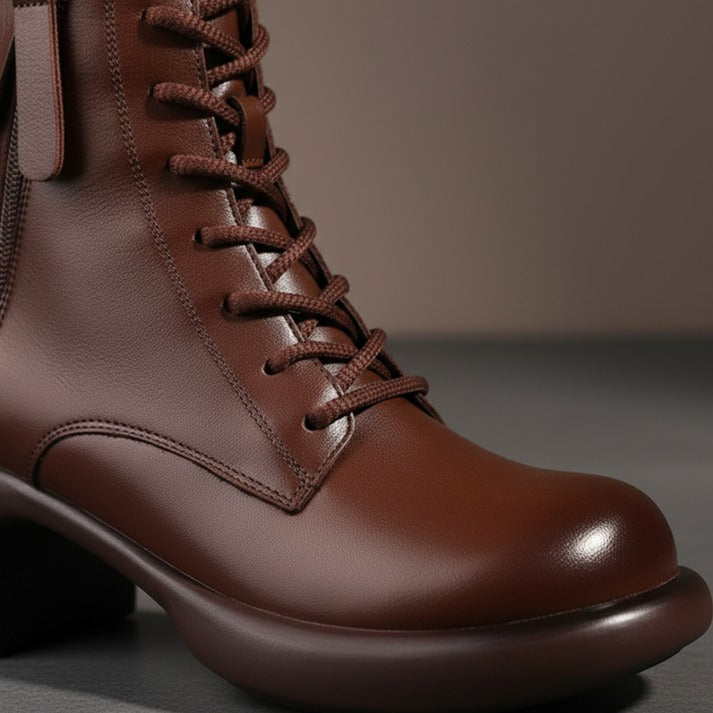 Brown leather lace up ankle boot with a rounded toe, front view