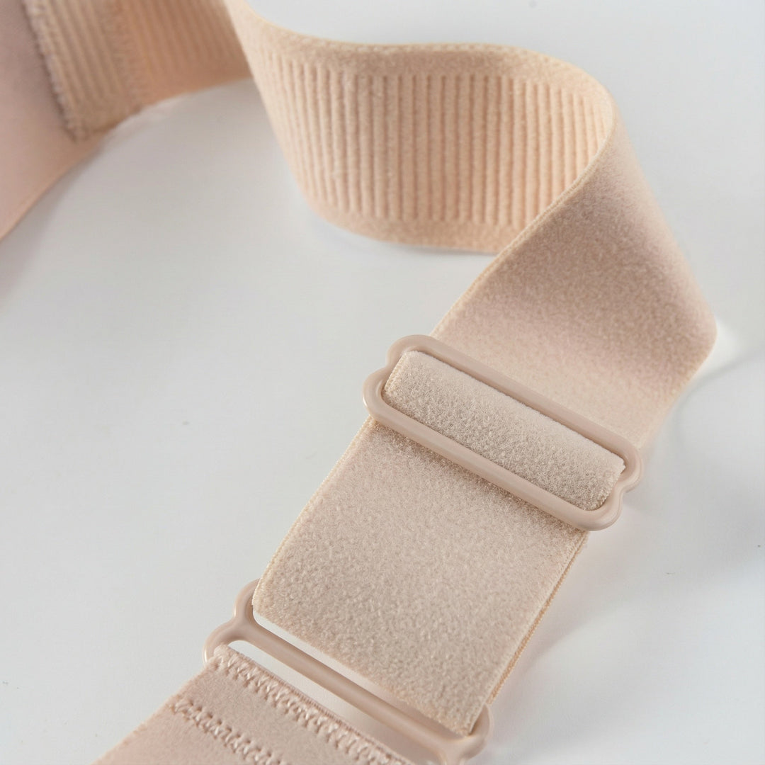 Wide elastic strap with its slider on a nude bra