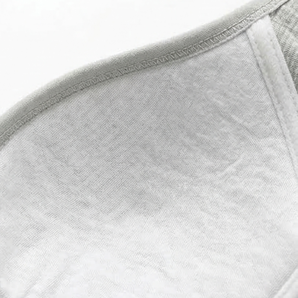 White cotton lining inside a grey ribbed bra