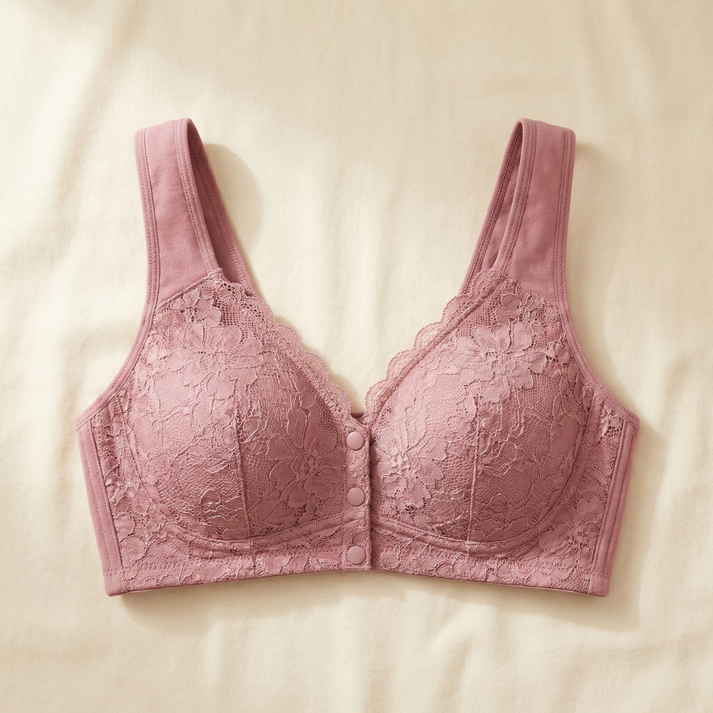 Dusty pink lace front-snap bra laid flat on linen