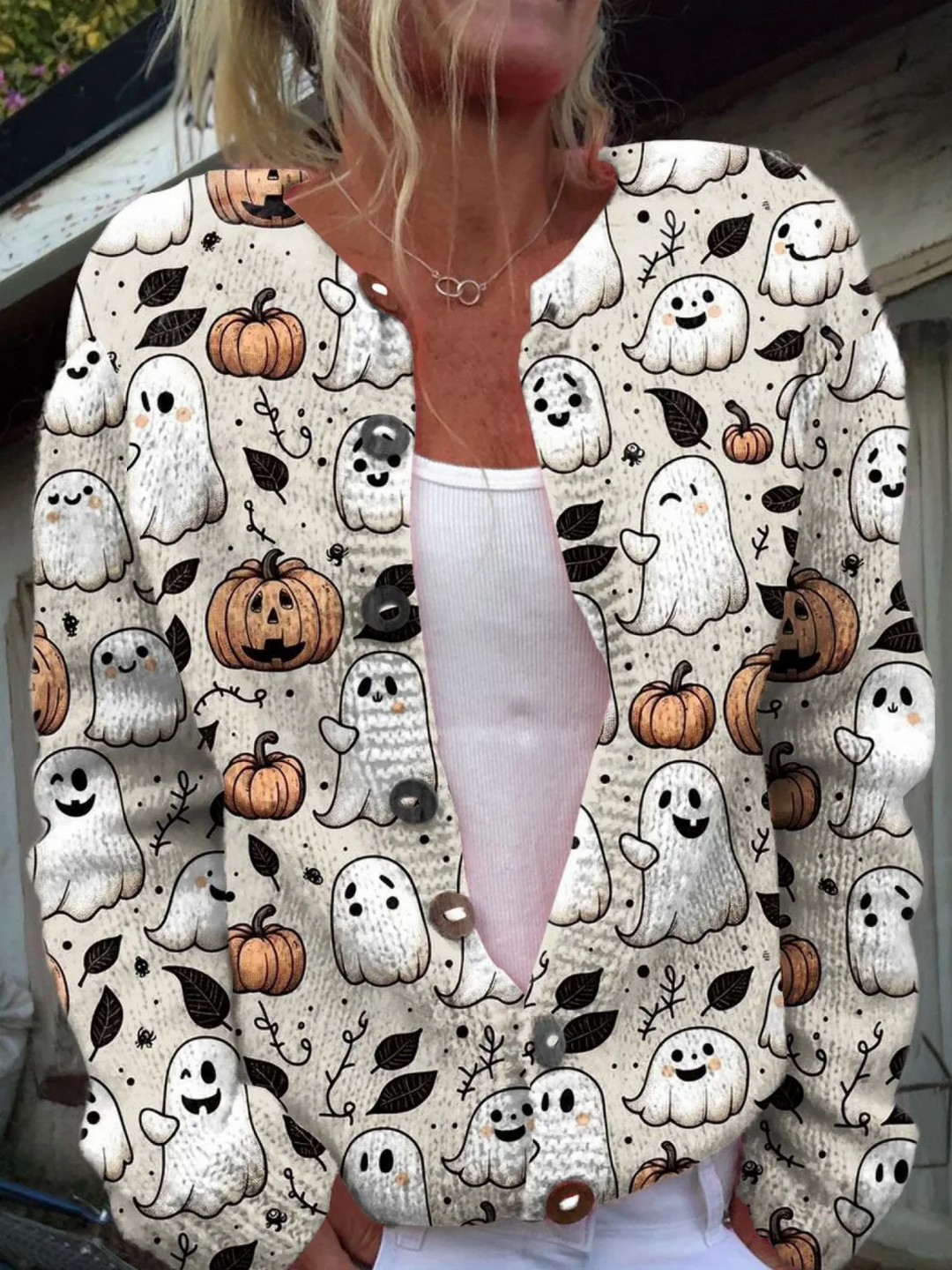 Cream button front cardigan with a cartoon ghost and pumpkin print, front view