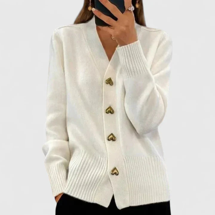 White knit cardigan with gold heart-shaped buttons