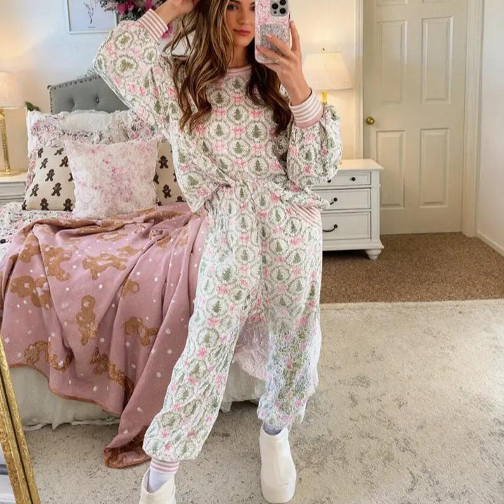 Woman in a wreath and bow print lounge set with striped cuffs