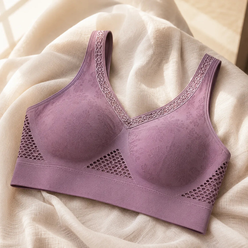 Mauve wireless lift bra laid flat on cream fabric