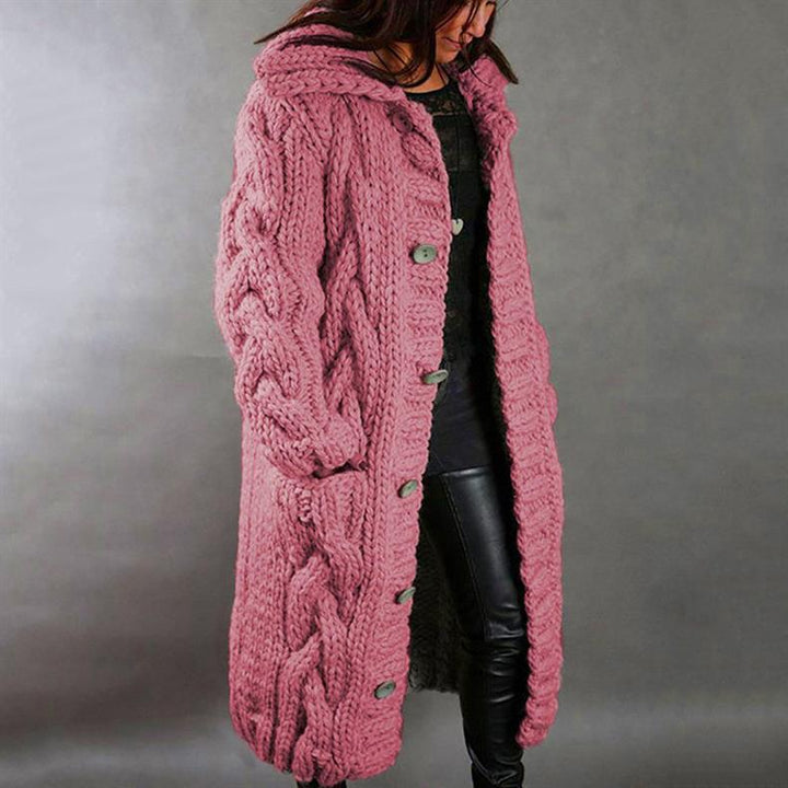 Pink hooded cable knit longline coat over leather leggings