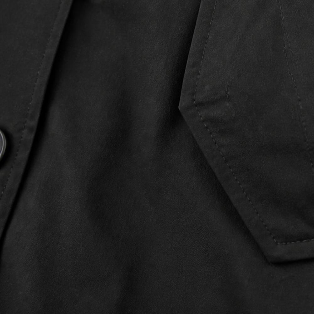 Set in sleeve seam on a black cotton hooded coat
