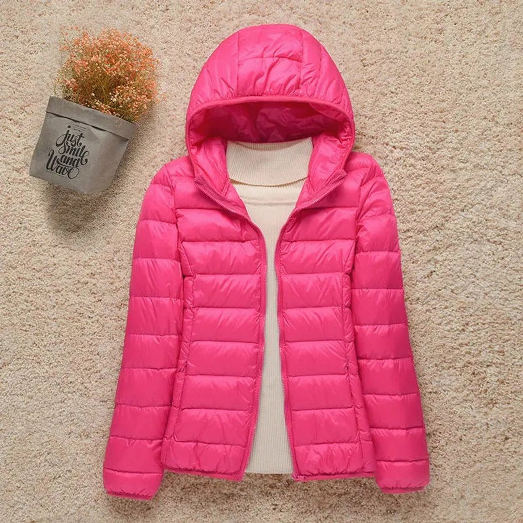 Hot pink hooded packable puffer jacket laid flat