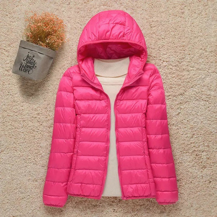 Hot pink hooded packable puffer jacket laid flat