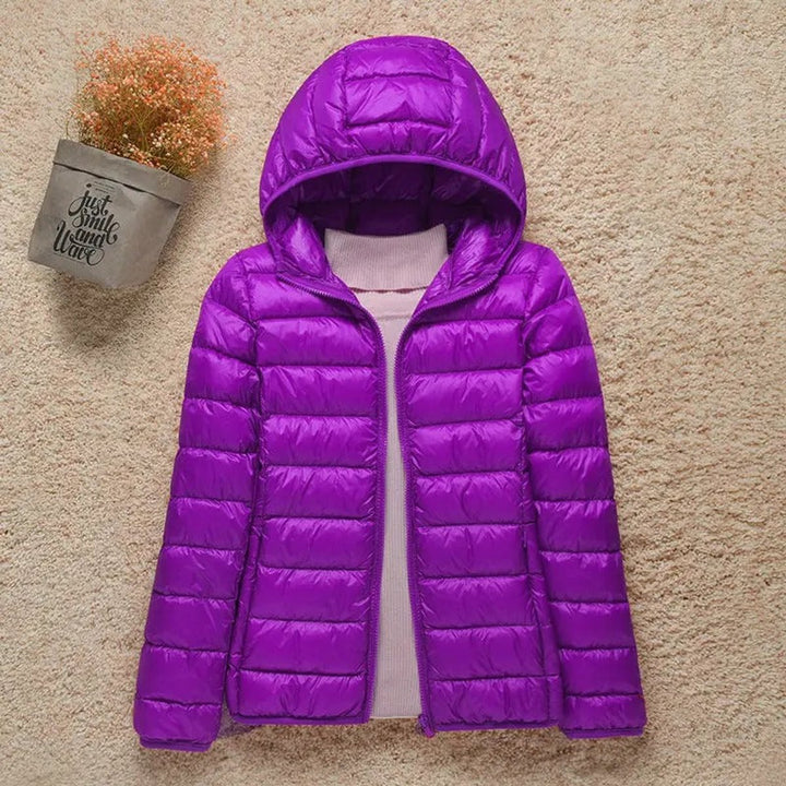 Purple hooded packable puffer jacket laid flat