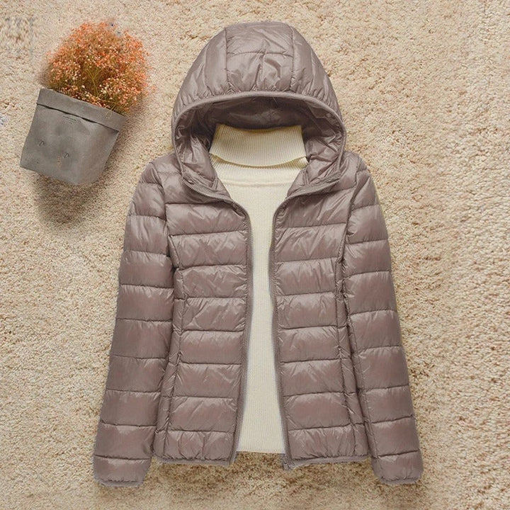 Taupe hooded packable puffer jacket laid flat