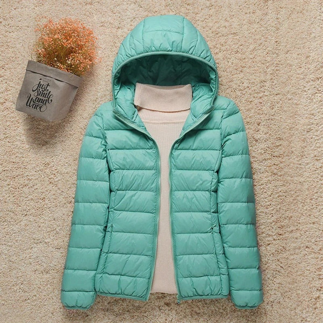 Mint hooded packable puffer jacket laid flat