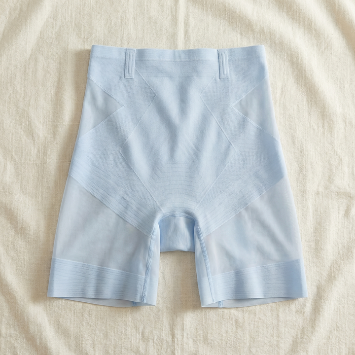 Pale blue ice silk shaping shorts laid flat on linen