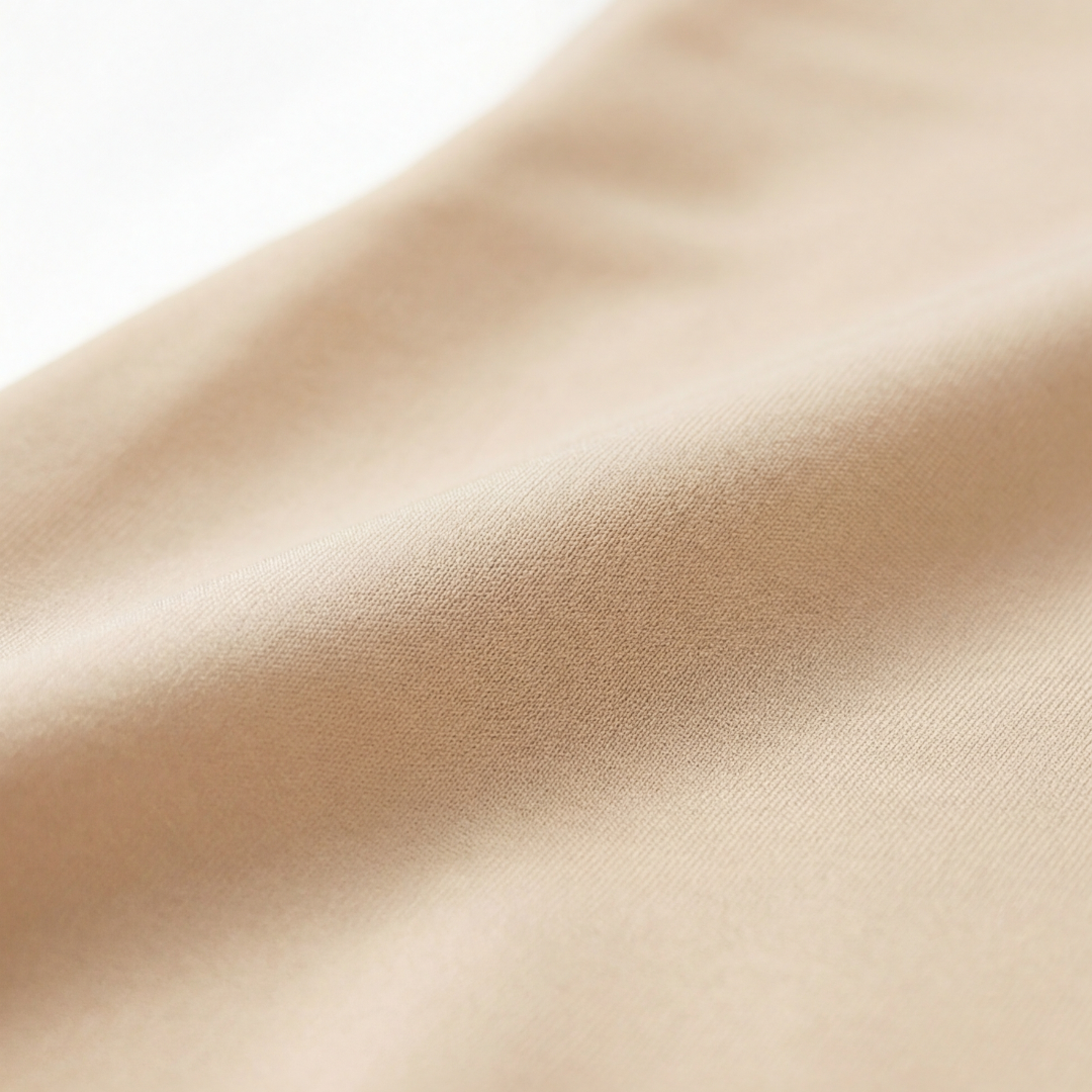 Close-up of the smooth nude ice silk fabric in soft folds
