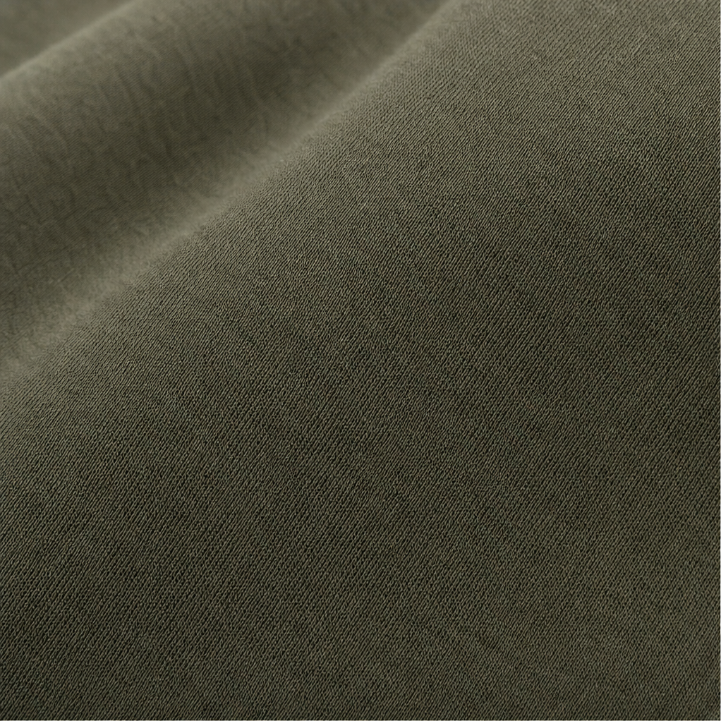 Close up of the smooth olive jersey fabric