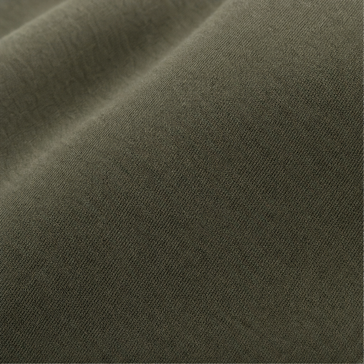 Close up of the smooth olive jersey fabric