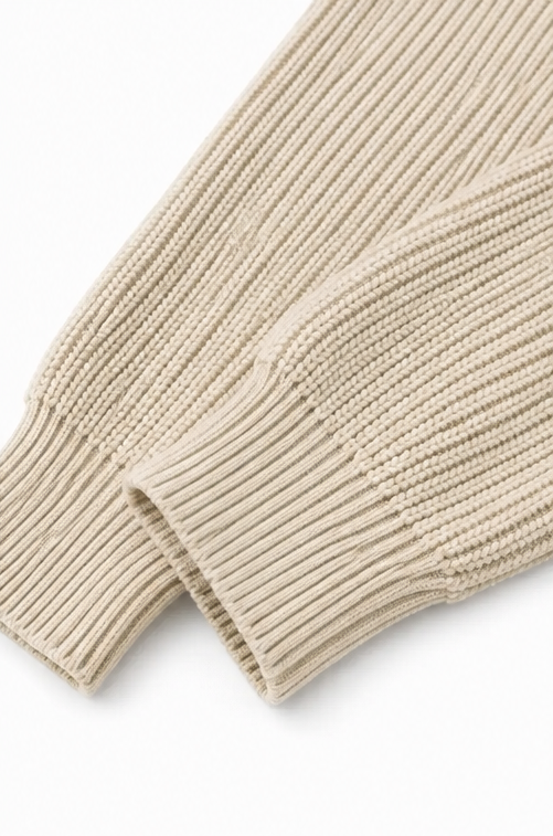 Ribbed cable knit sleeve and cuff on a cream quilted jacket