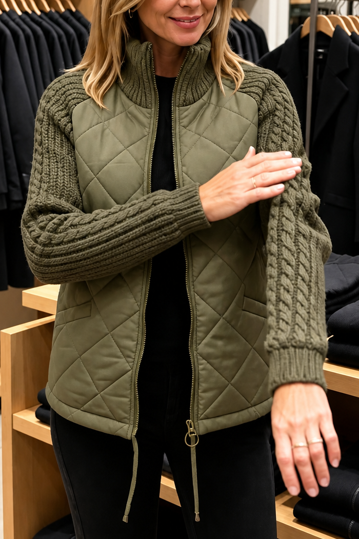 Olive quilted jacket with chunky cable knit sleeves and a zip front