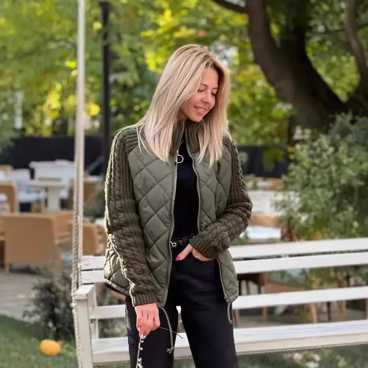 Olive knit panel quilted jacket worn with a shoulder bag outdoors