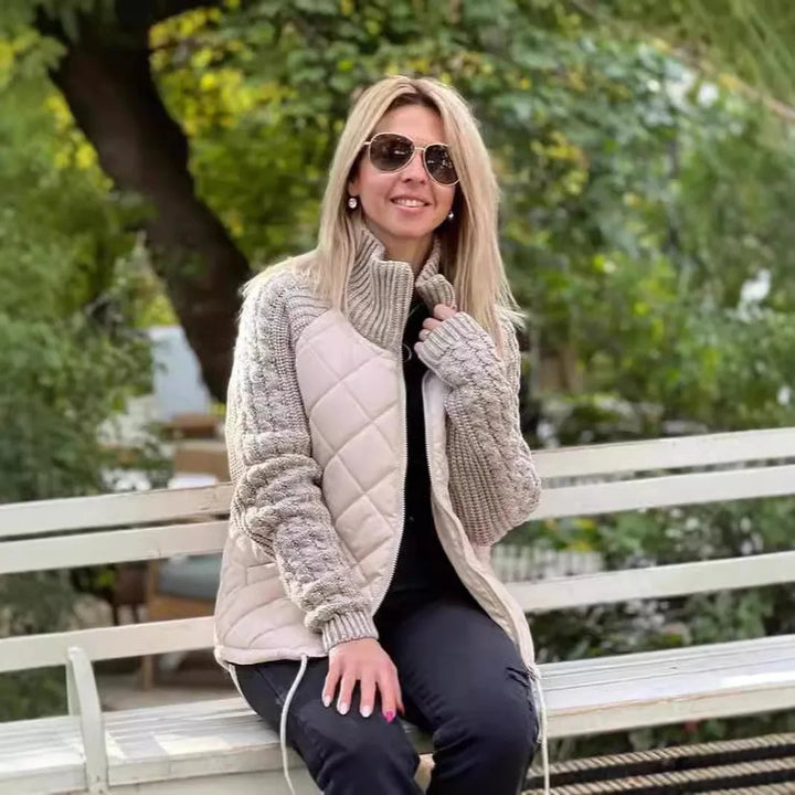 Cream quilted jacket with cable knit sleeves worn on a park bench