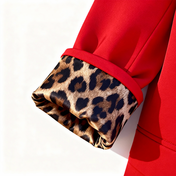 Leopard print lining revealed in the turned back cuff of a red blazer