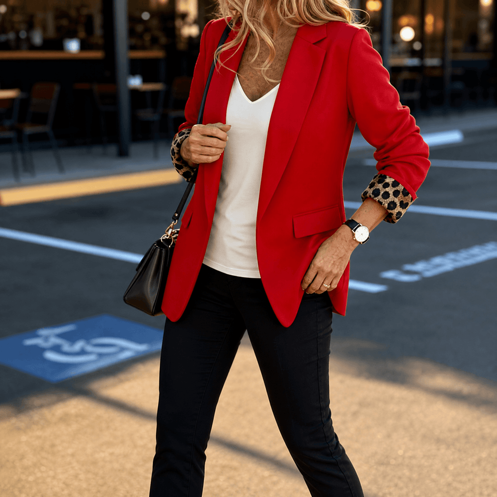 Red tailored blazer with leopard print lined cuffs and black jeans