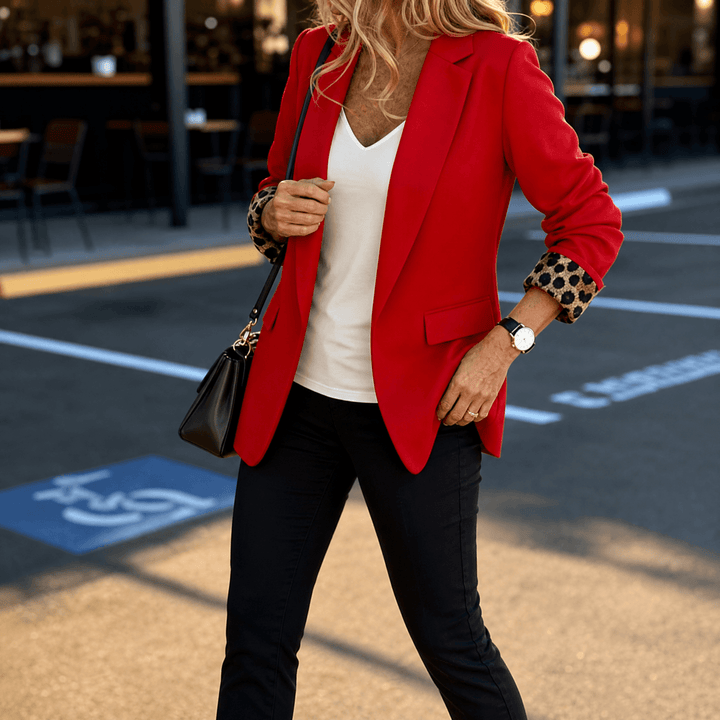 Red tailored blazer with leopard print lined cuffs and black jeans