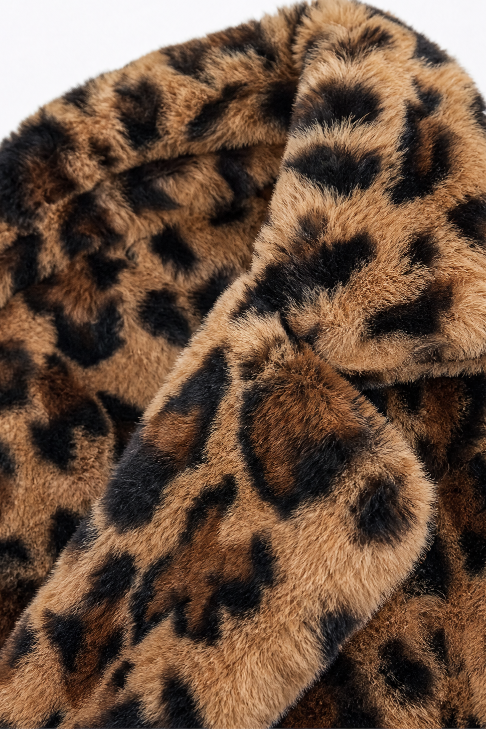 Shawl collar detail on a leopard print faux fur coat
