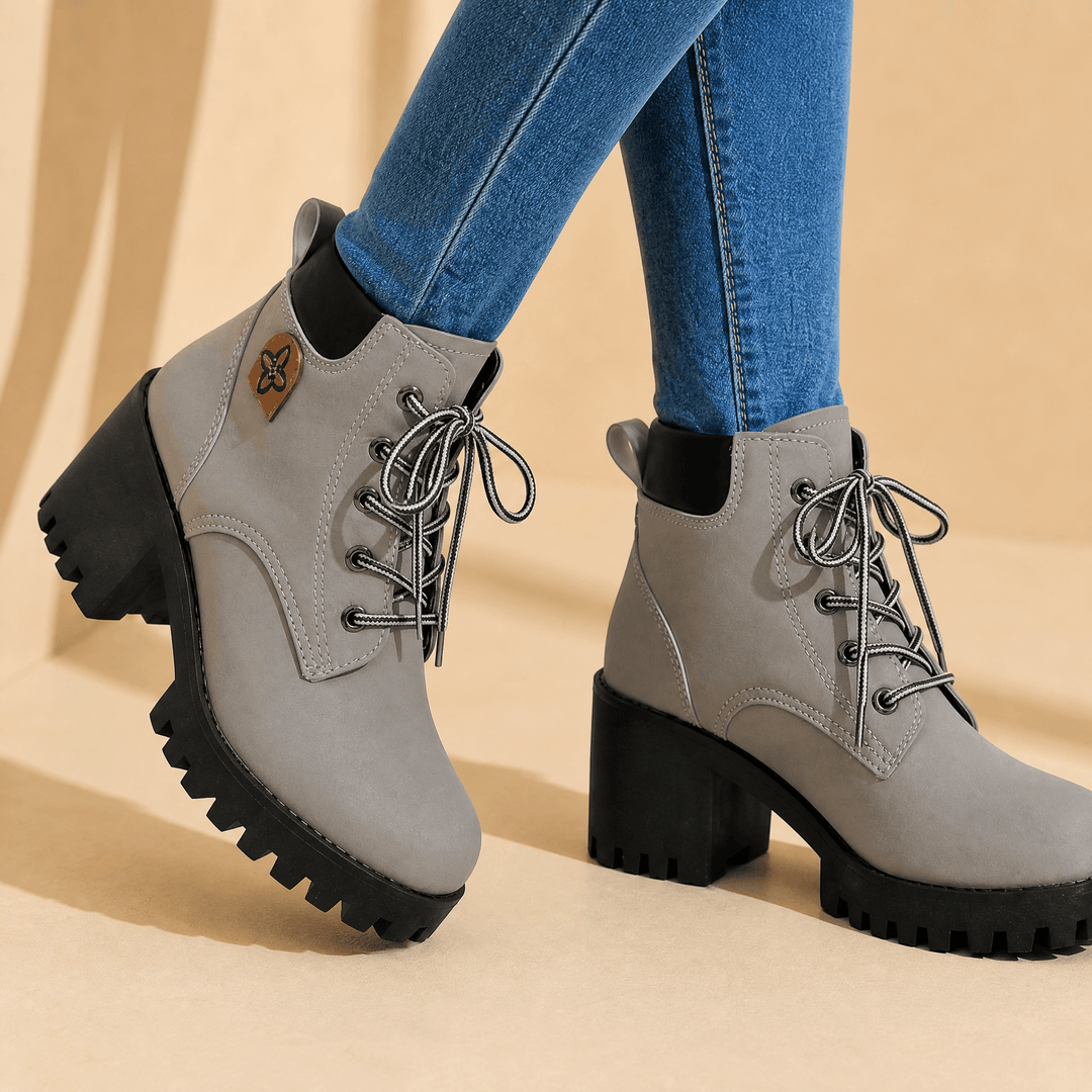 Grey lace-up platform boots with chunky black lug soles worn with jeans