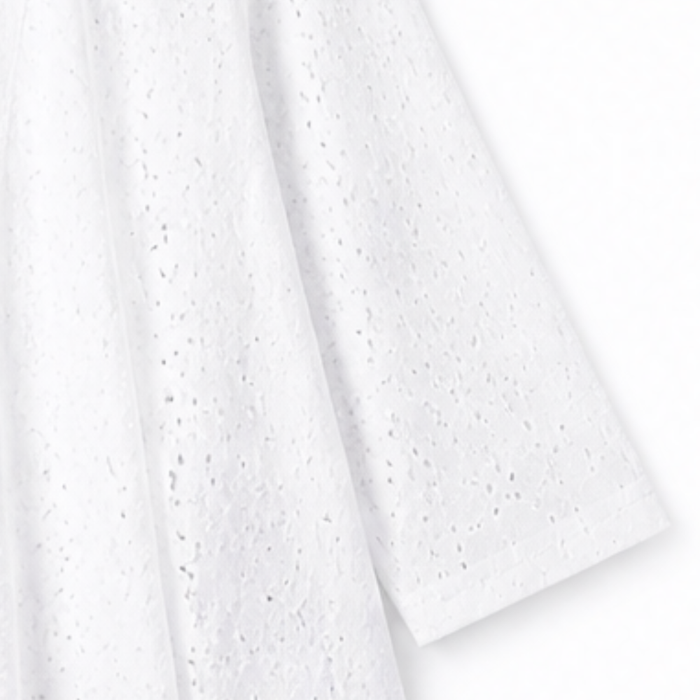 Draped white eyelet fabric on a lightweight open front cardigan
